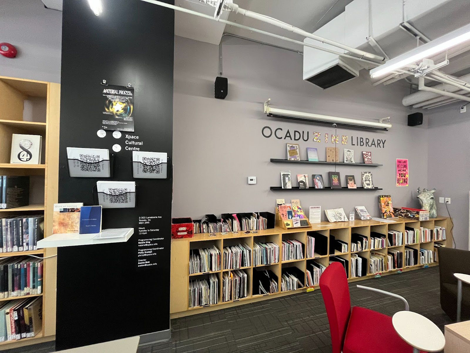 Learning Zone photo featuring a gray wall with rows of books and art